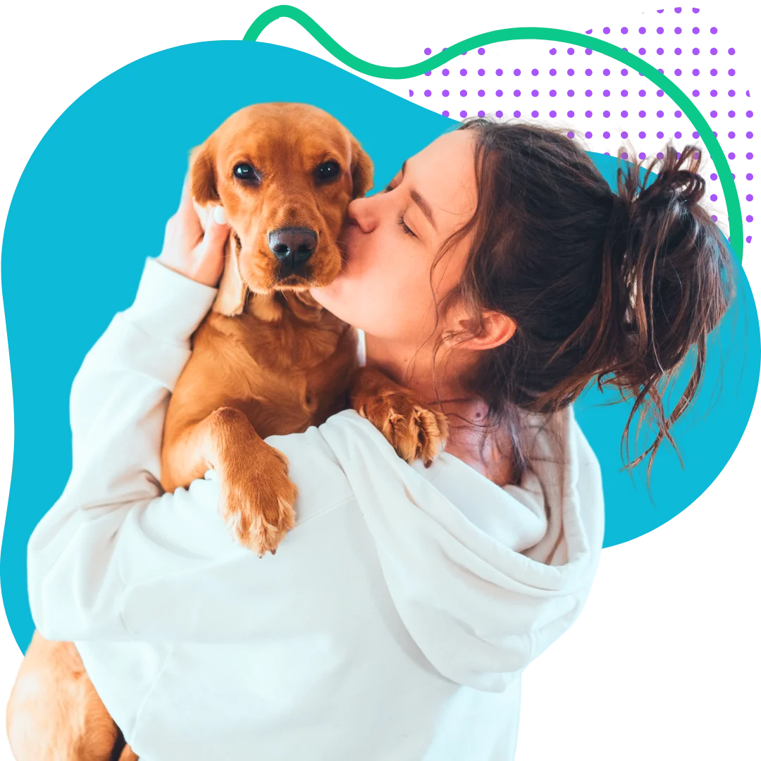 woman holding her dog in her arms while giving him a smooch with a colorful abstract background